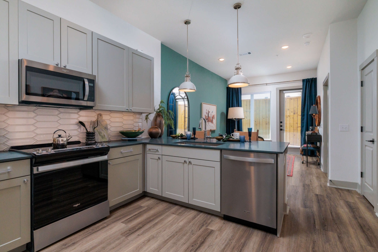 Furnished apartment kitchen and living room inside a model home at The Briarly