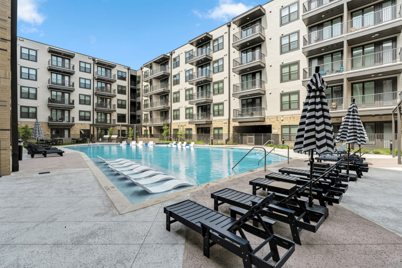 The Briarly apartment community swimming pool with ample deck seating